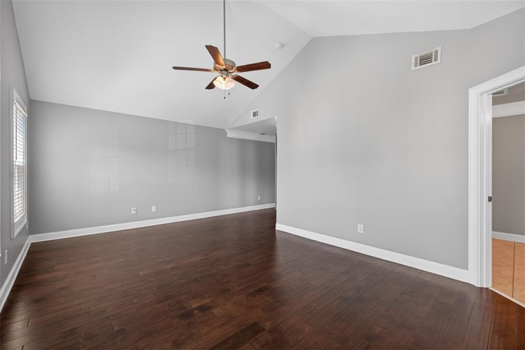 2854 Jordan Oaks Lane, Unit 8 Decatur, GA 30033 - Photo 19 of 41 an empty room with wooden floor fan and windows