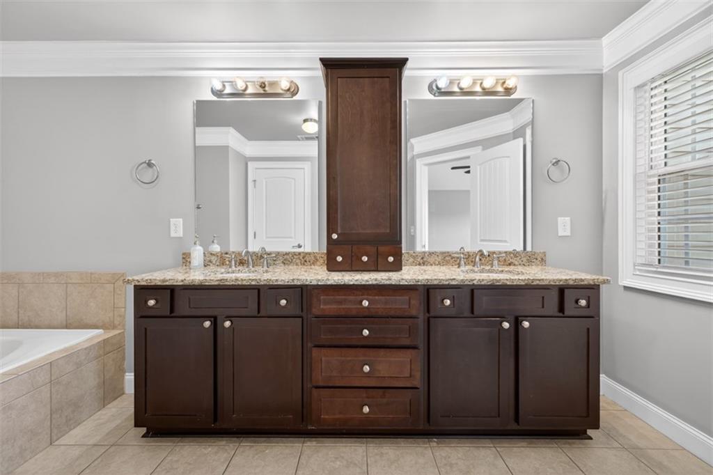 2854 Jordan Oaks Lane, Unit 8 Decatur, GA 30033 - Photo 20 of 41 a bathroom with a granite countertop sink and a mirror