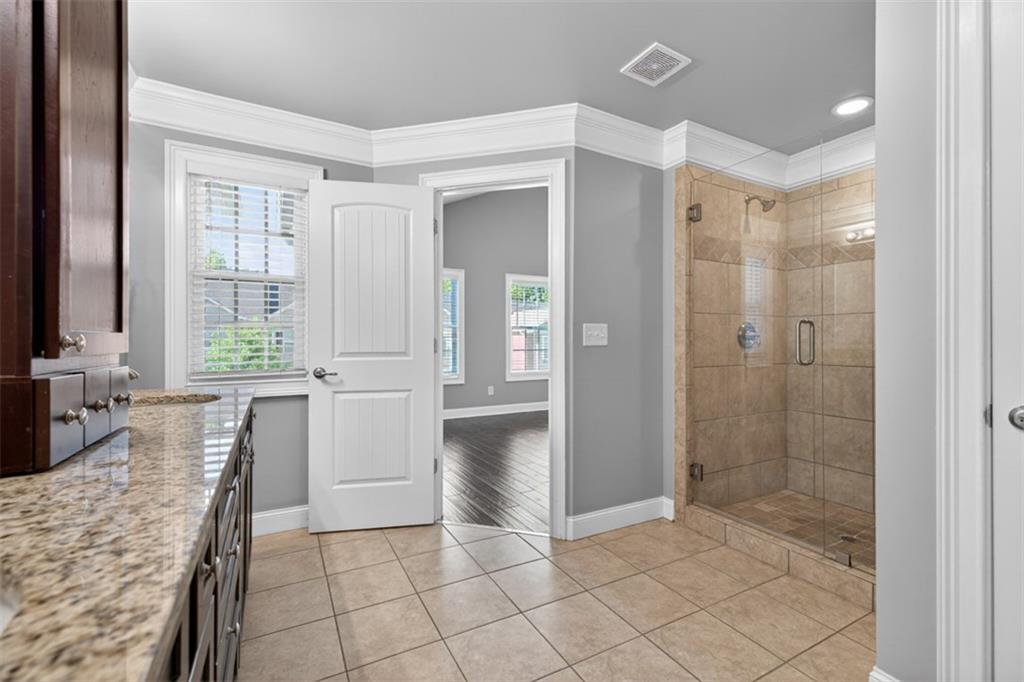 2854 Jordan Oaks Lane, Unit 8 Decatur, GA 30033 - Photo 24 of 41 a bathroom with a granite countertop sink a large mirror and a bathtub