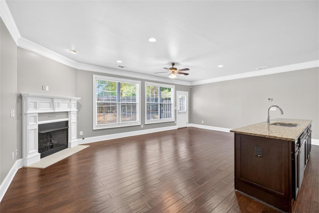 2854 Jordan Oaks Lane, Unit 8 Decatur, GA 30033 - Photo 5 of 41 a view of an empty room with wooden floor fireplace and a window