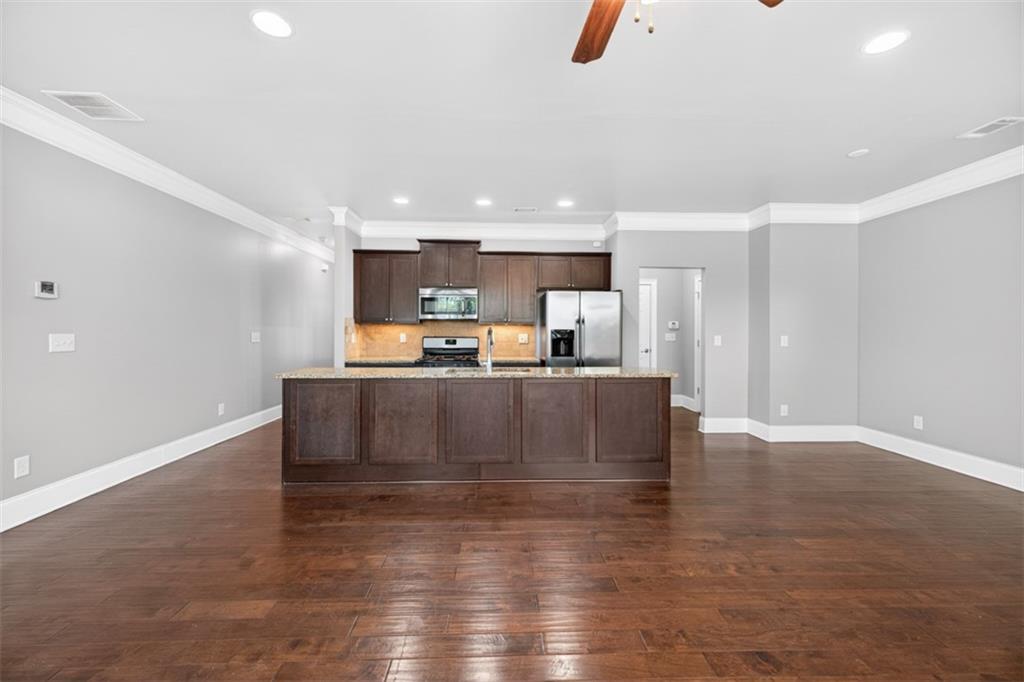 2854 Jordan Oaks Lane, Unit 8 Decatur, GA 30033 - Photo 8 of 41 a living room with kitchen island furniture and a kitchen view