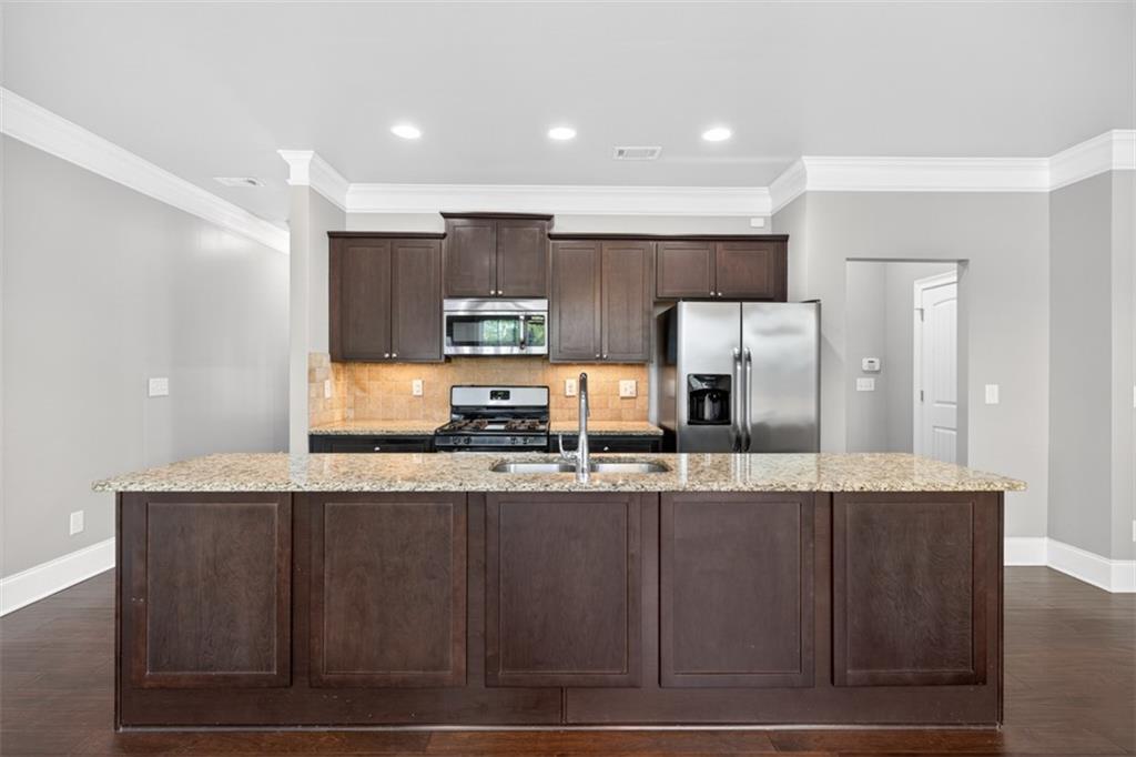 2854 Jordan Oaks Lane, Unit 8 Decatur, GA 30033 - Photo 9 of 41 a large kitchen with granite countertop a sink a counter top space and stainless steel appliances