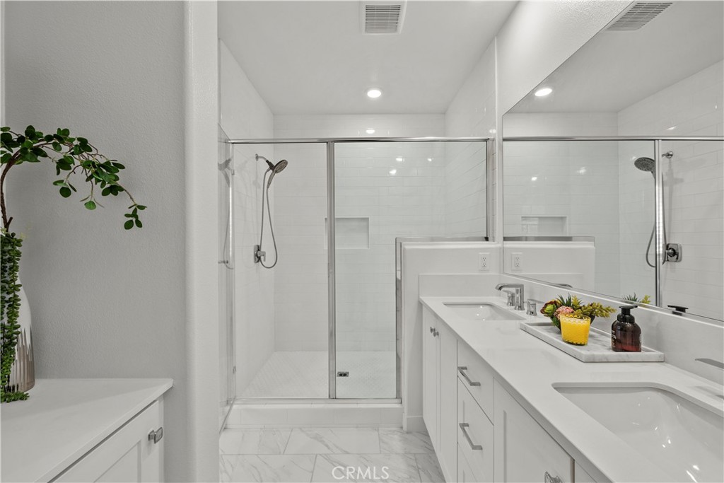 1663 Rosewell Road West Covina, CA 91791 - Photo 22 of 45 a bathroom with a shower sink and mirror