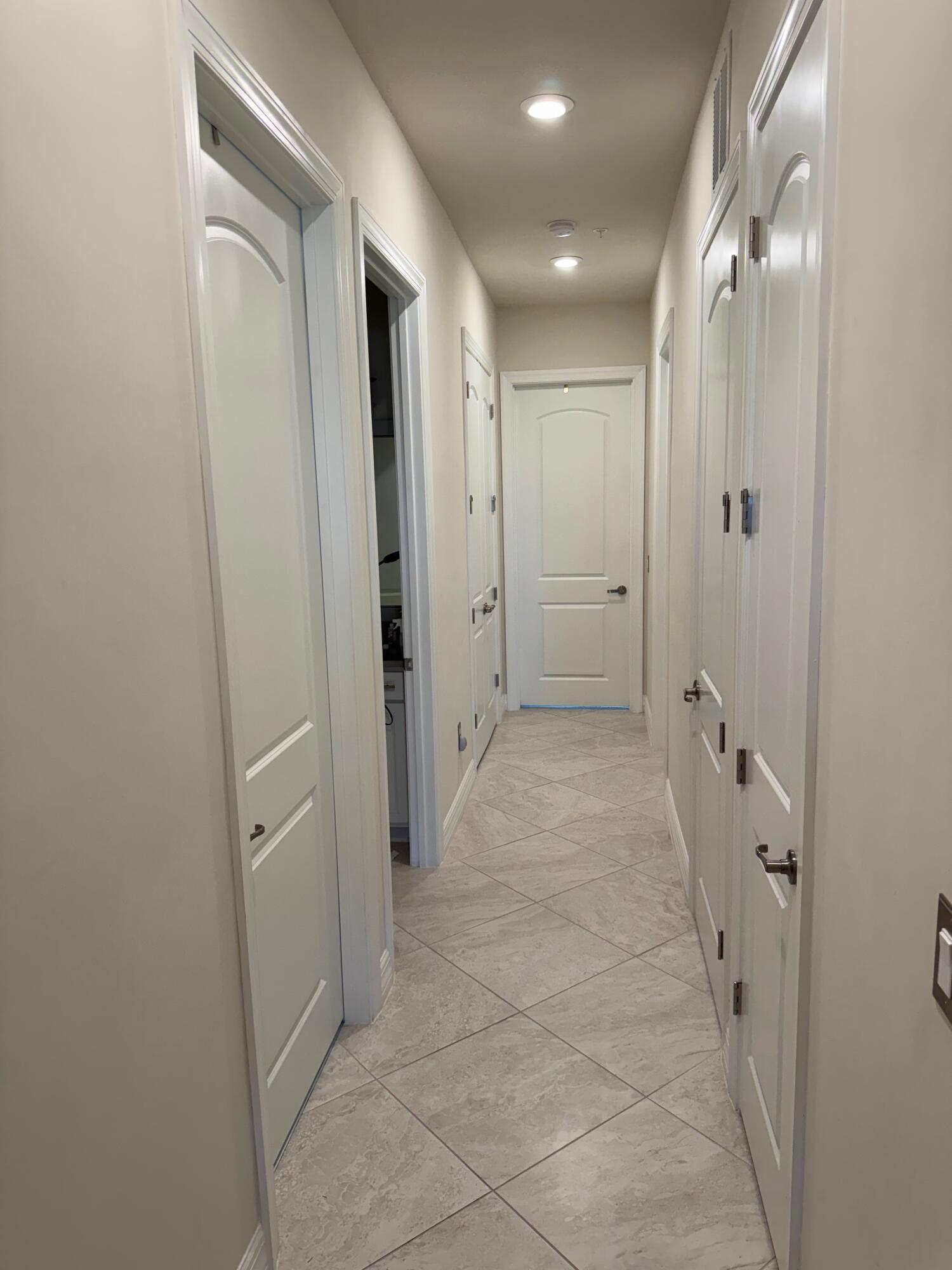 21872 Canadensis Circle, Unit 202 Boca Raton, FL 33428 - Photo 13 of 43 hallway to bedrooms