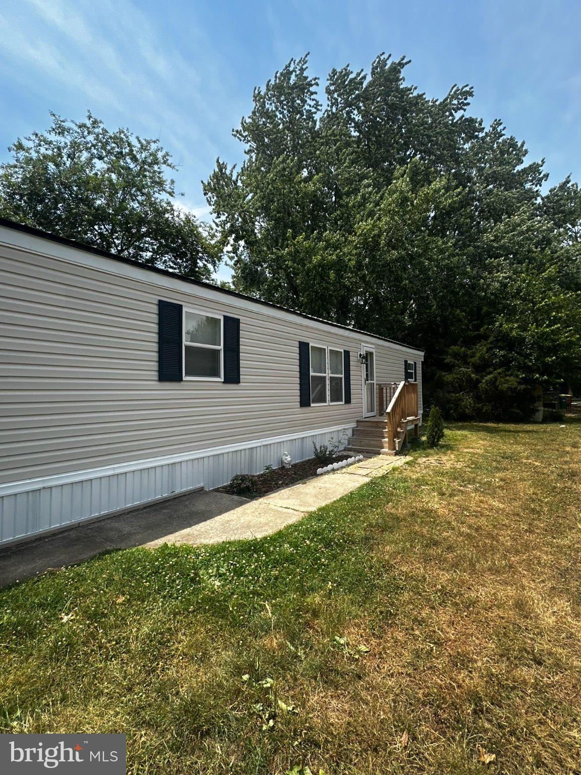 31777 Siham Road Lewes, DE 19958 - Photo 46 of 46 Charming mobile home with lush greenery.
