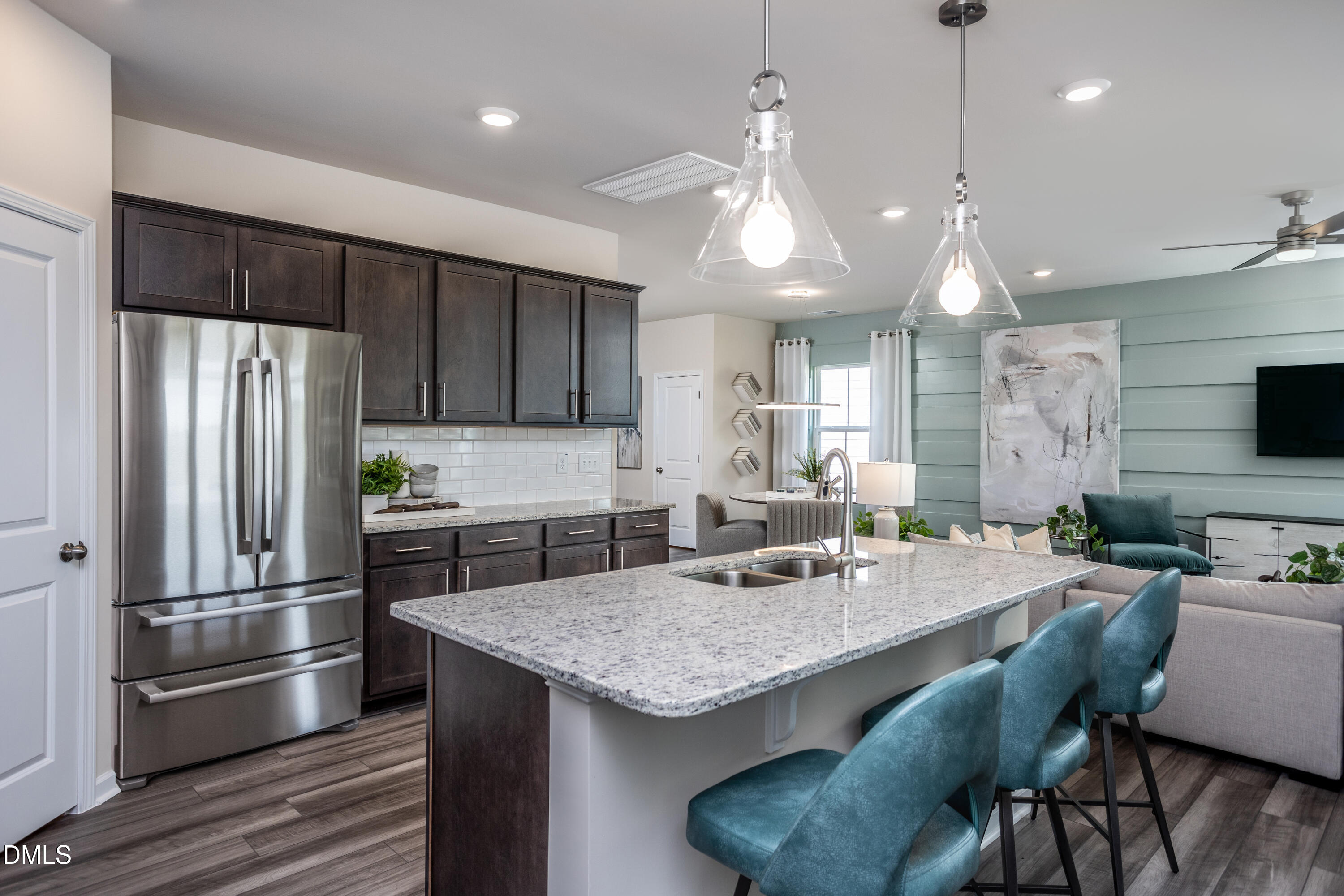 636 Fosterton Cottage Way Raleigh, NC 27603 - Photo 5 of 29 a kitchen with granite countertop a refrigerator a stove a sink dishwasher a dining table and chairs with wooden floor