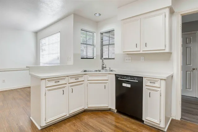 a kitchen with granite countertop white cabinets and white appliances