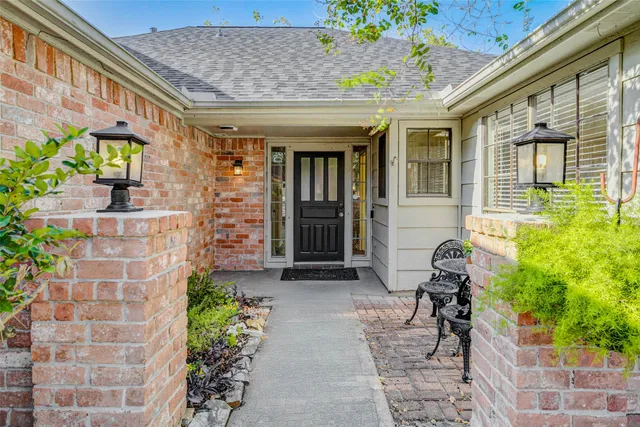a view of a brick house with potted plants