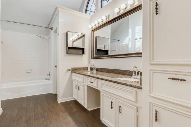 a spacious bathroom with a granite countertop sink and a mirror