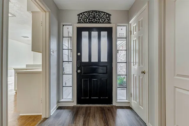 a view of walk in closet with wooden floor