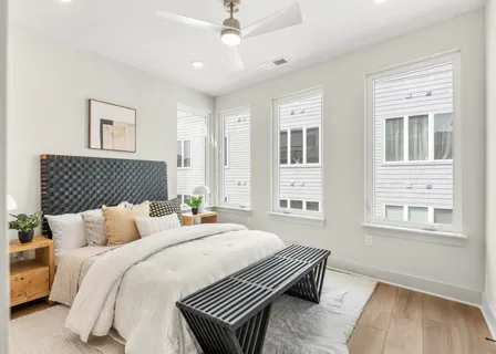 a bedroom with bed and wooden floor
