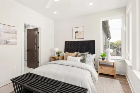 a bedroom with a bed and wooden floor