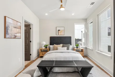 a bedroom with a bed and wooden floor