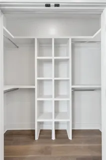 a view of a room with wooden floor