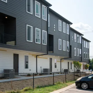 a car parked in front of a brick house