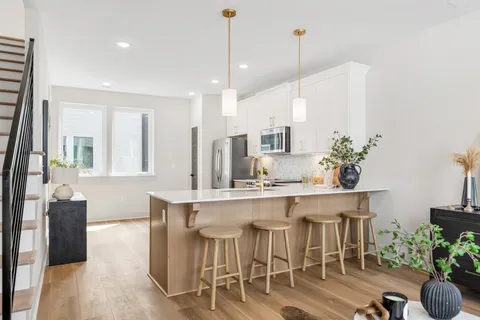 a large kitchen with a table and chairs