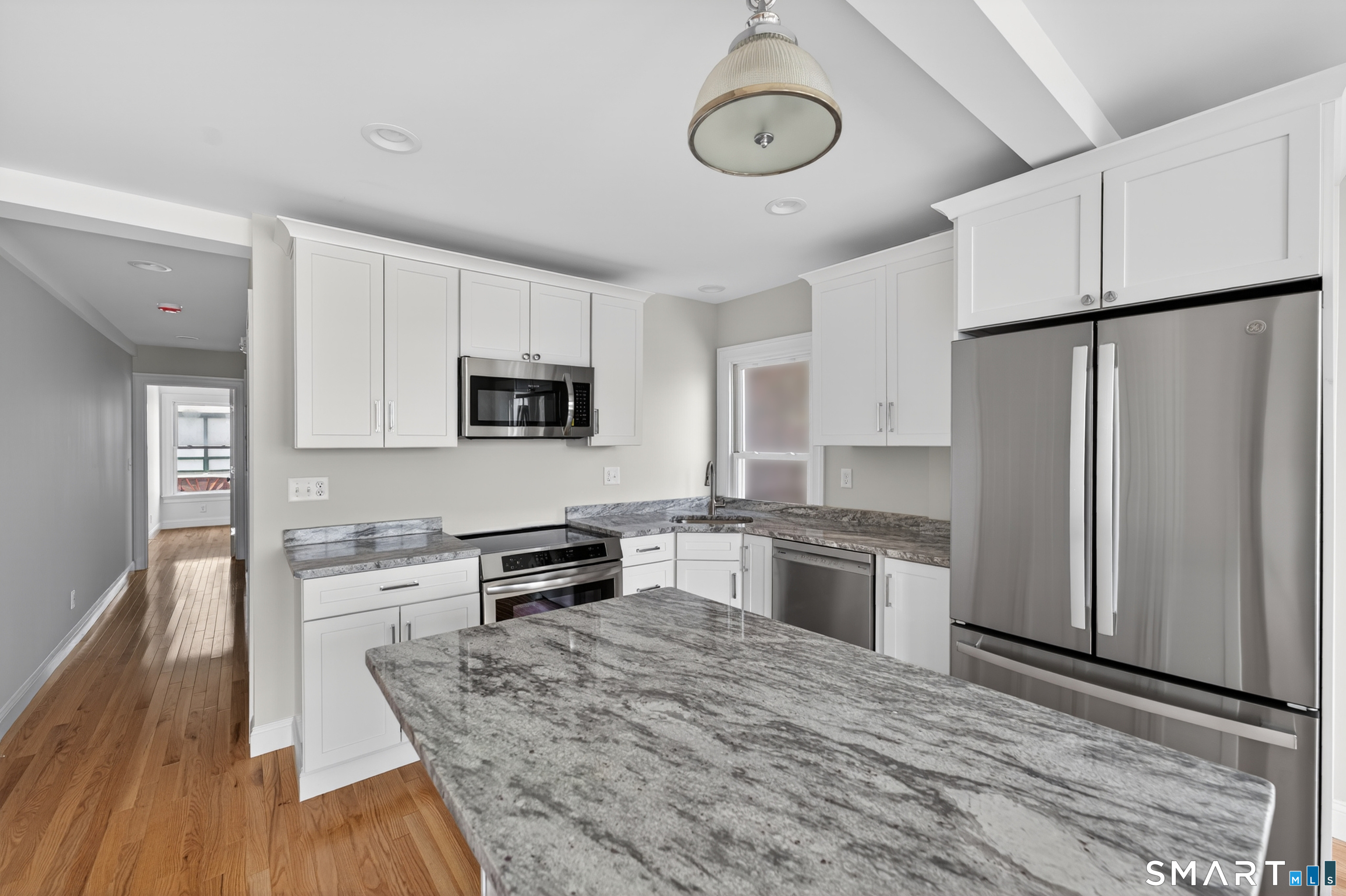 138 Bank Street, Unit 2A New London, CT 06320 - Photo 13 of 22 a kitchen with granite countertop a refrigerator stove top oven and sink