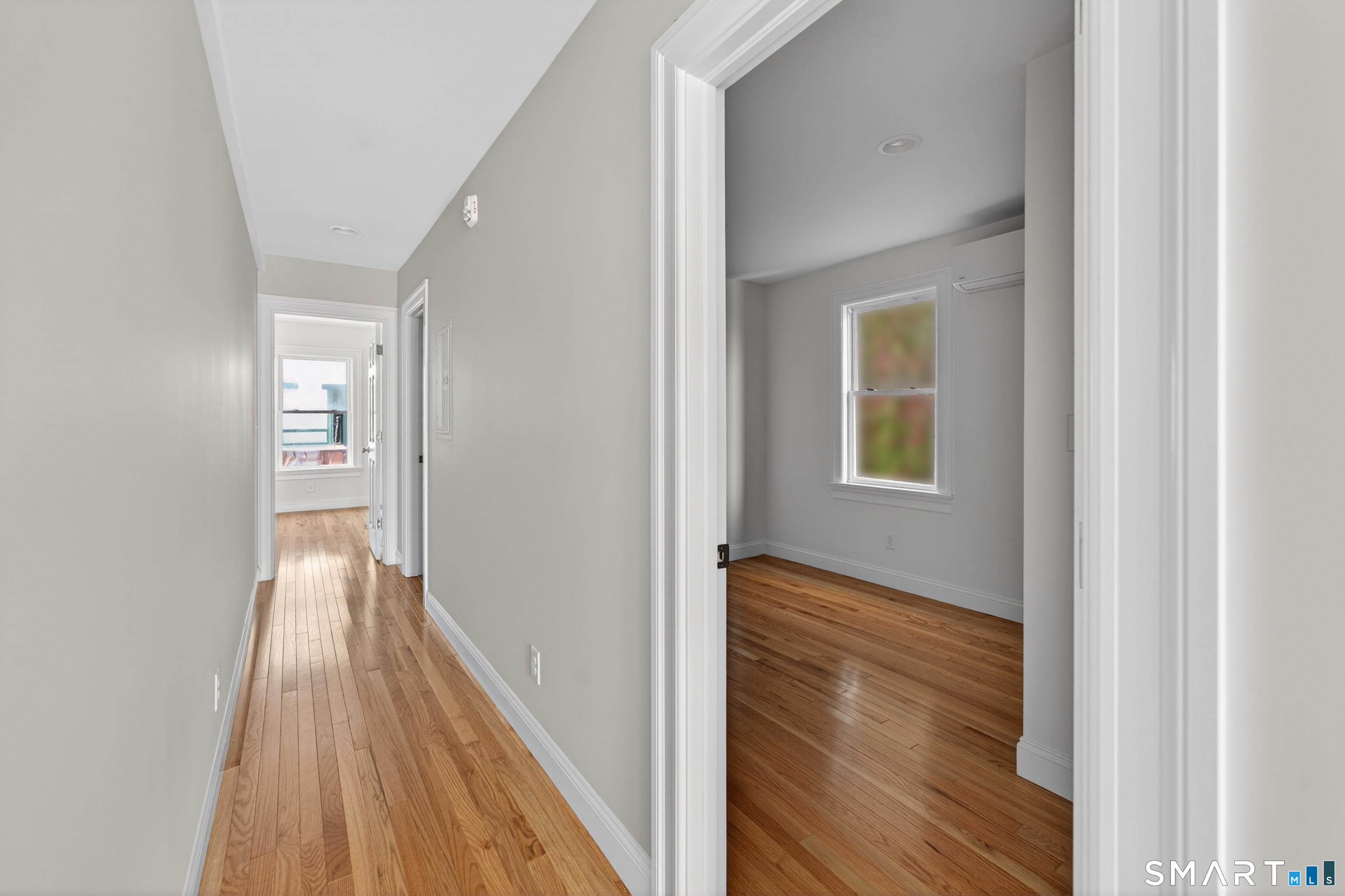 138 Bank Street, Unit 2A New London, CT 06320 - Photo 15 of 22 a view of a hallway with wooden floor and staircase