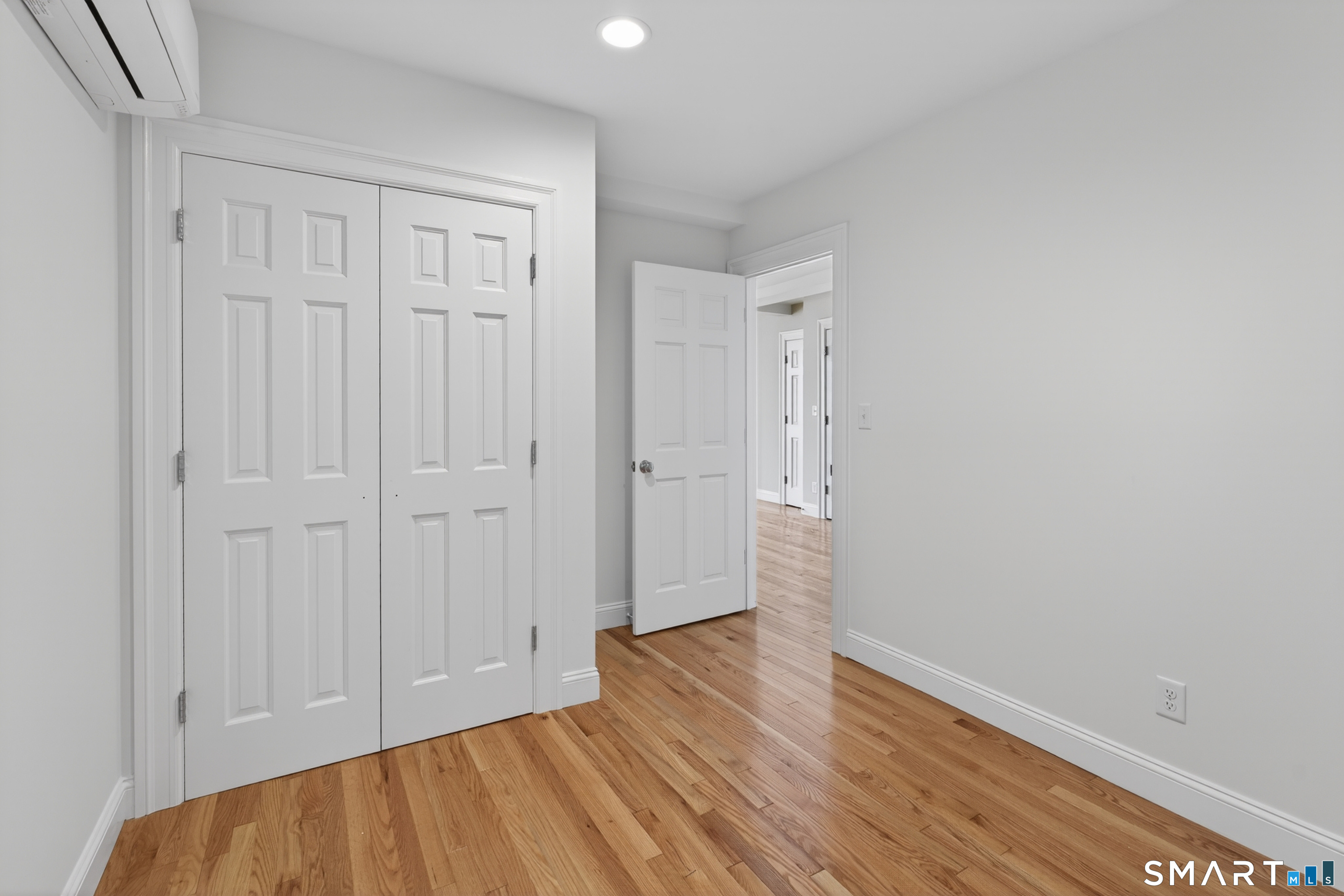 138 Bank Street, Unit 2A New London, CT 06320 - Photo 17 of 22 a view of an empty room with wooden floor