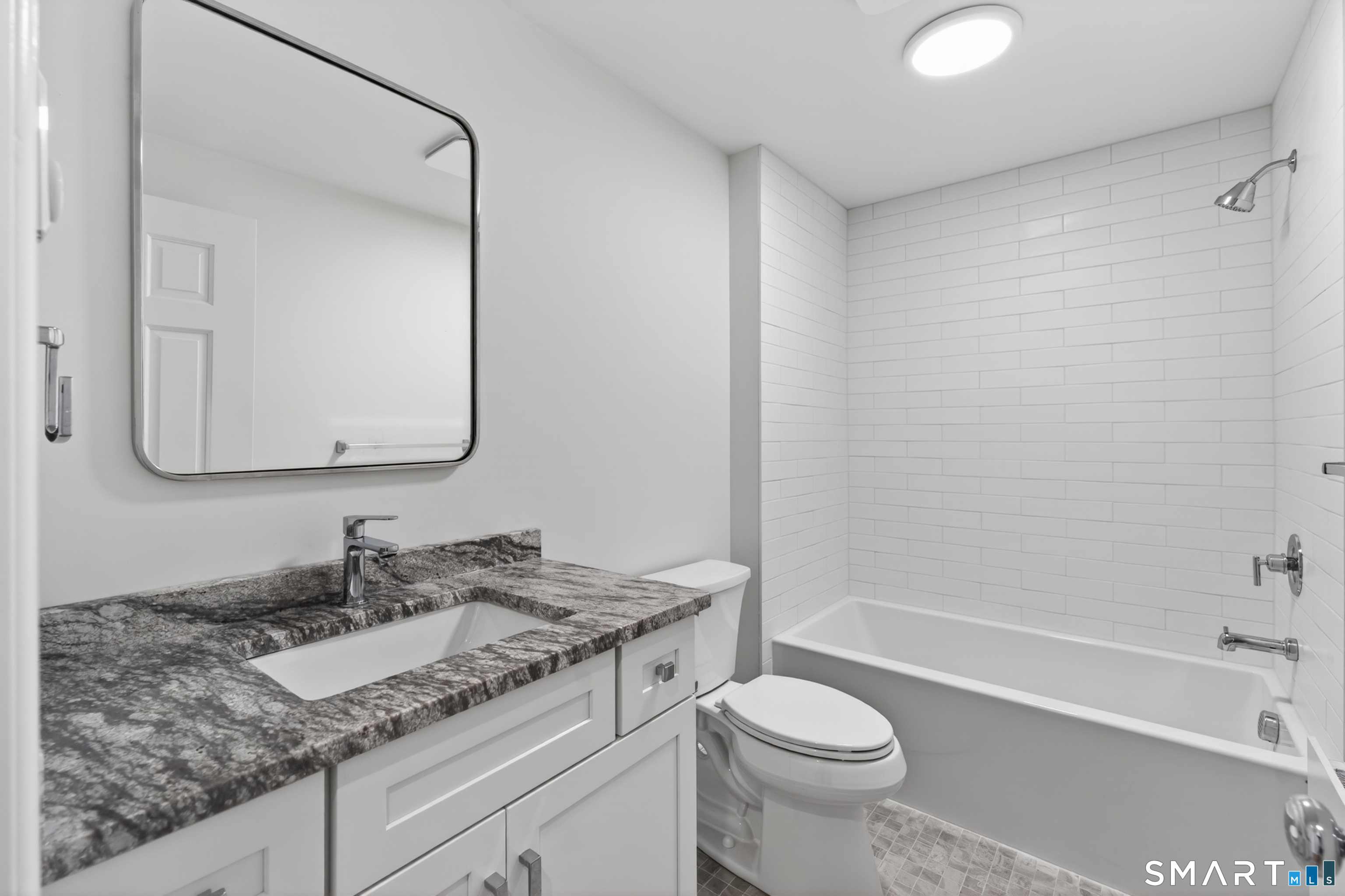 138 Bank Street, Unit 2A New London, CT 06320 - Photo 19 of 22 a bathroom with a granite countertop sink toilet and shower