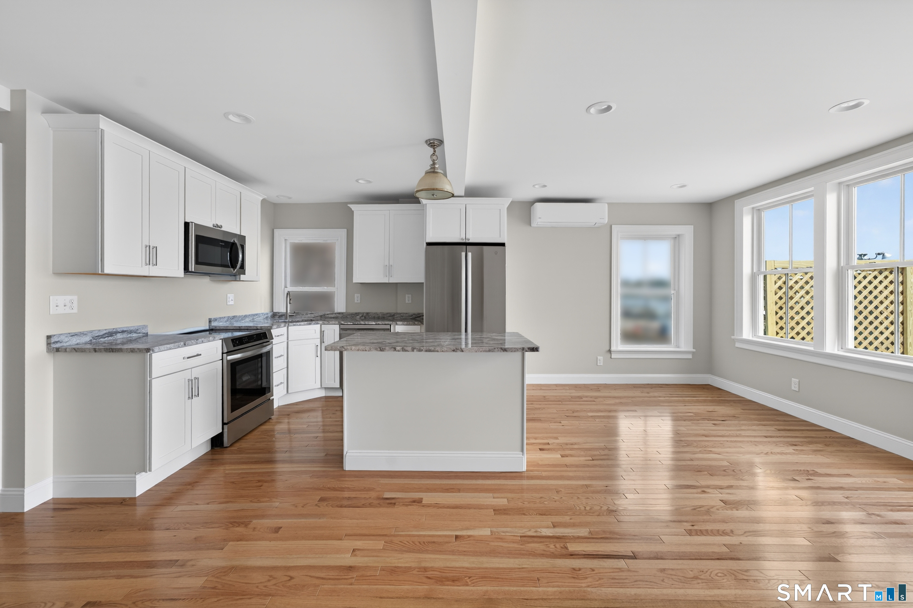 138 Bank Street, Unit 2A New London, CT 06320 - Photo 7 of 22 a living room with stainless steel appliances kitchen island granite countertop a stove and a refrigerator
