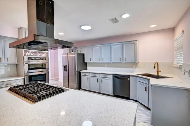 a kitchen with a stove a sink and a refrigerator