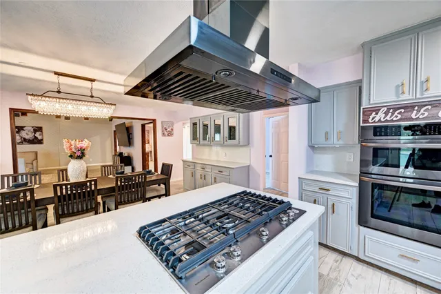 a kitchen with stainless steel appliances granite countertop a stove and a refrigerator