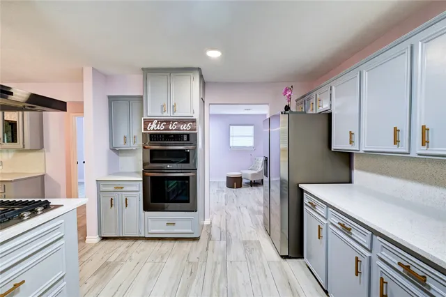 a kitchen with stainless steel appliances a stove a microwave and a refrigerator