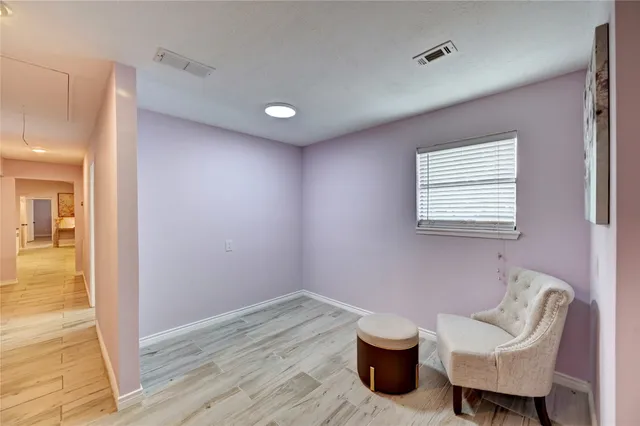 a view of a room with wooden floor and chair