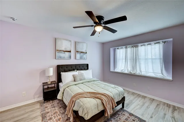 a bedroom with a large bed and a window