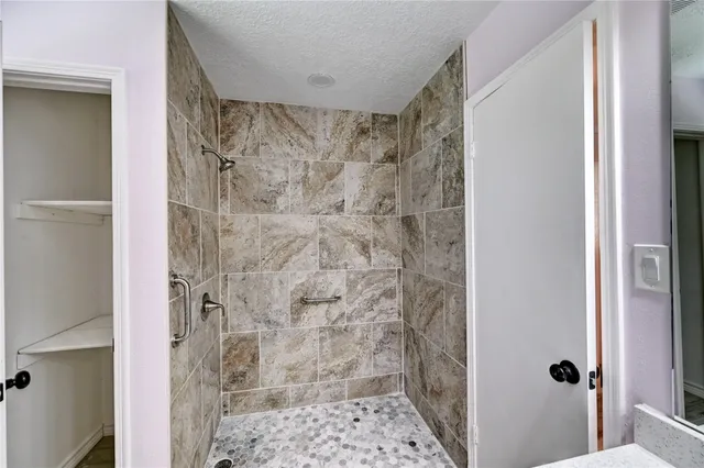 a bathroom with a shower and a sink