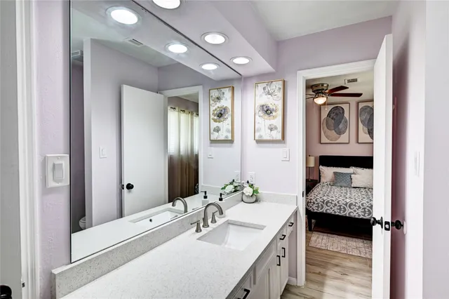 a en suite bathroom with a double vanity sink and a mirror