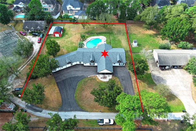 an aerial view of a house with a yard basket ball court and outdoor seating