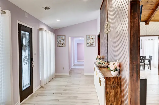 a view of an entryway with wooden floor