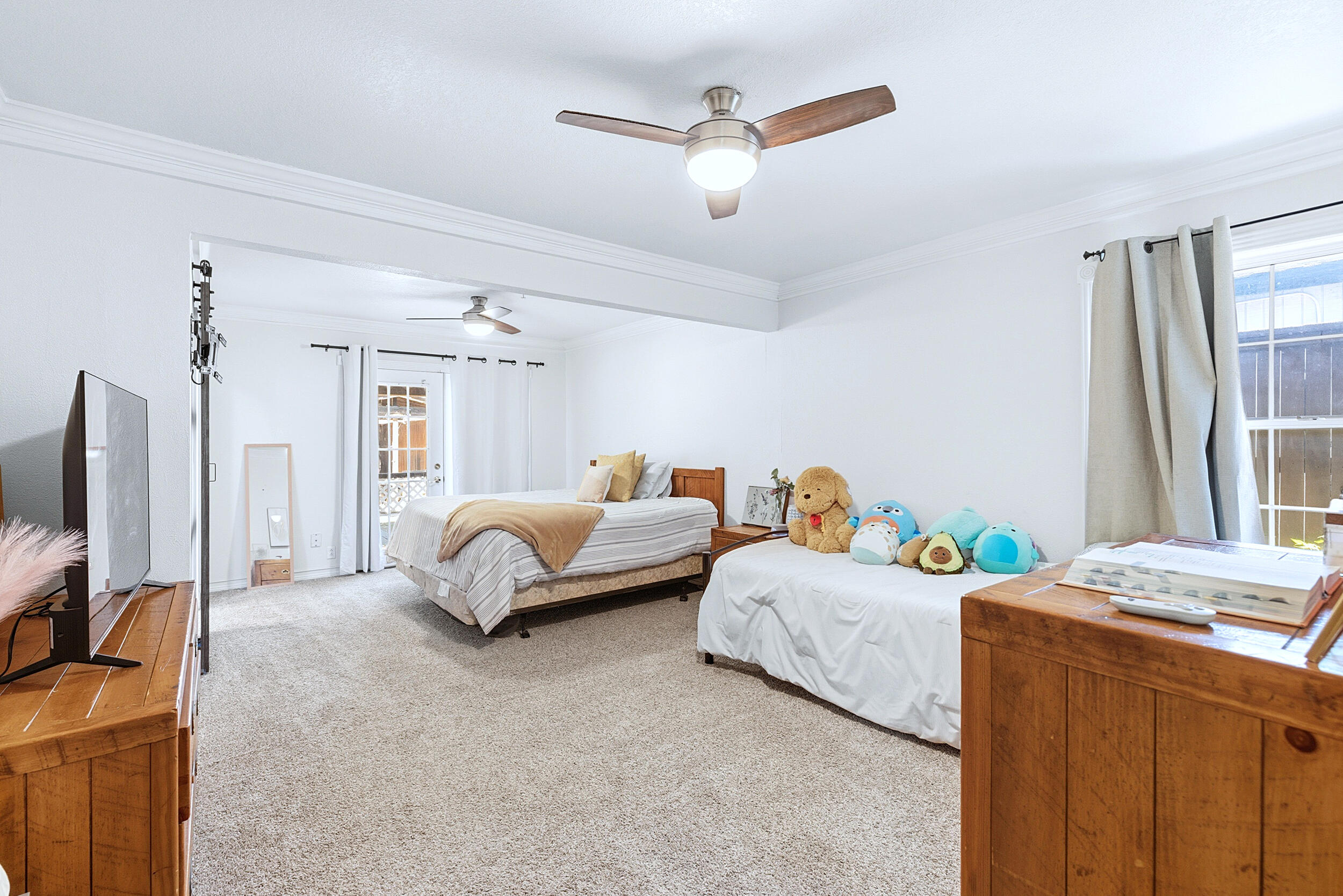 4210 44th Street Lubbock, TX 79413 - Photo 14 of 28 a bedroom with bed and a flat tv screen