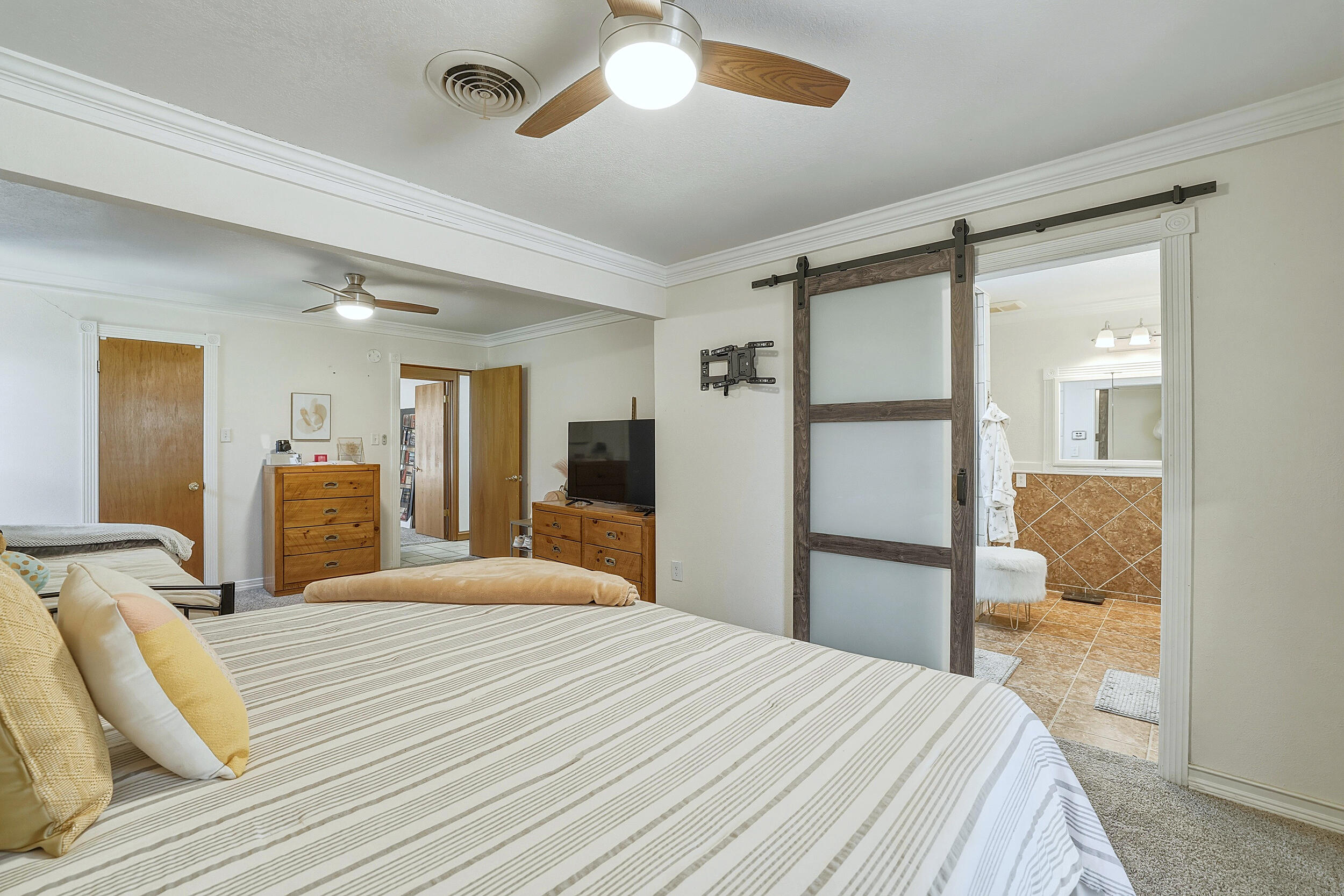4210 44th Street Lubbock, TX 79413 - Photo 15 of 28 a bedroom with a bed and a large mirror