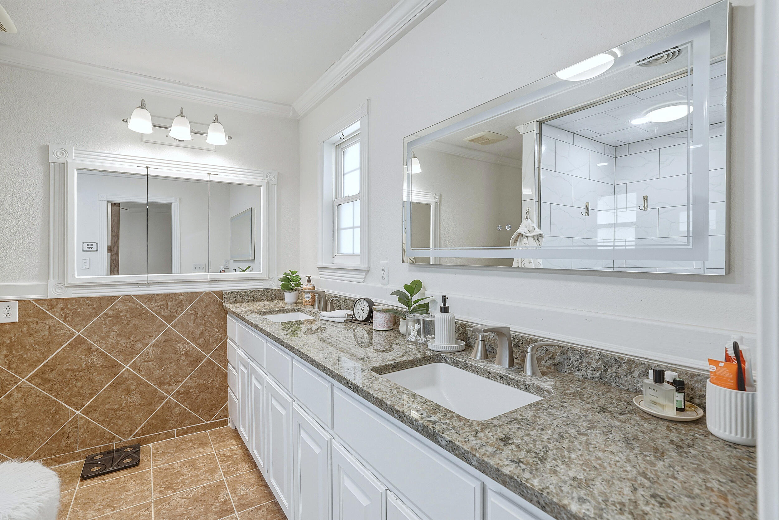 4210 44th Street Lubbock, TX 79413 - Photo 17 of 28 a bathroom with a granite countertop sink a mirror and a