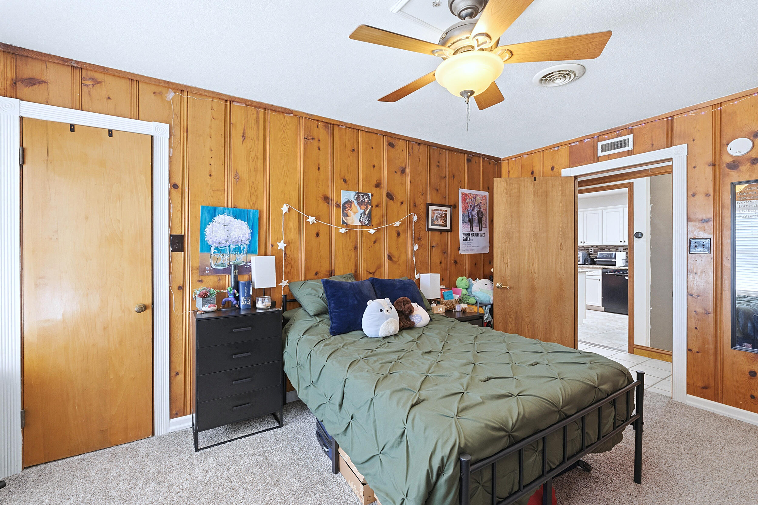 4210 44th Street Lubbock, TX 79413 - Photo 22 of 28 a bedroom with a bed and a chandelier
