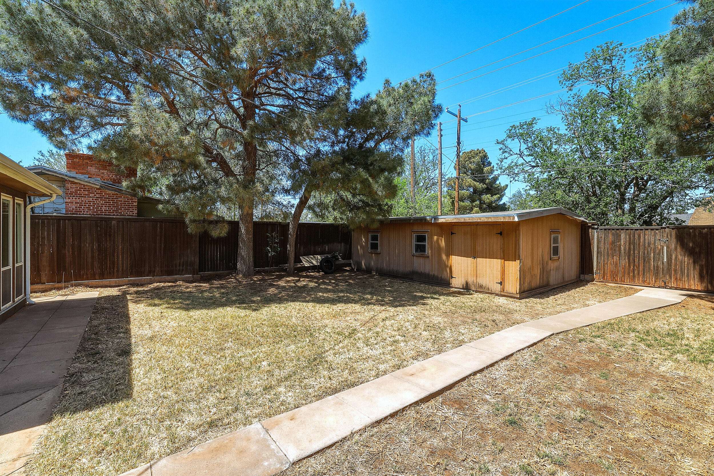 4210 44th Street Lubbock, TX 79413 - Photo 27 of 28 a white house that has a tree in front of it