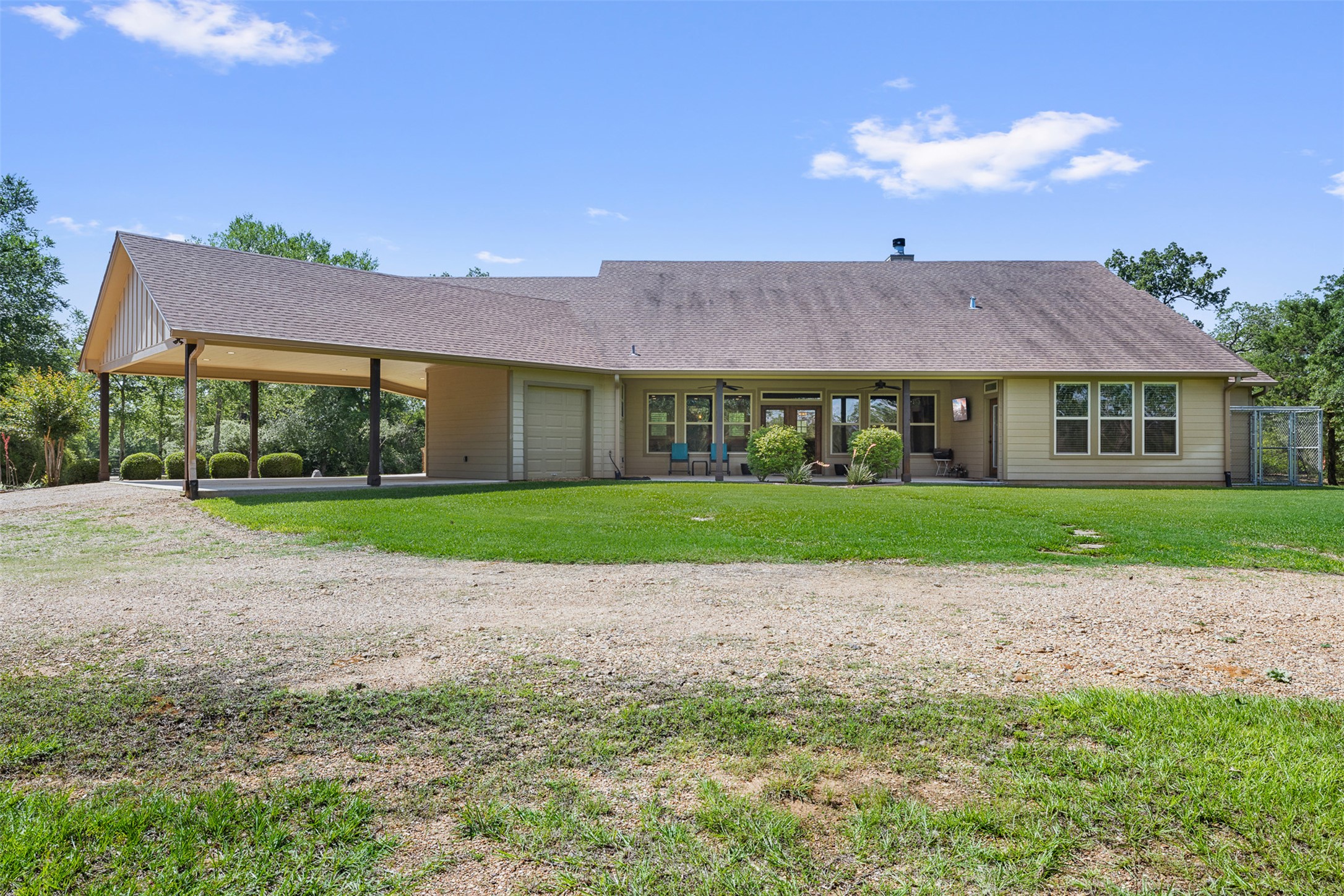 1306 22 Hills Road Gause, TX 77857 - Photo 8 of 40 Single-story home featuring a covered carport, attached garage, and a full-width covered patio