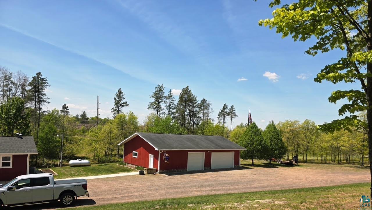11702 East Mail Road Gordon, WI 54838 - Photo 2 of 49 Detached red two-car garage with white overhead doors