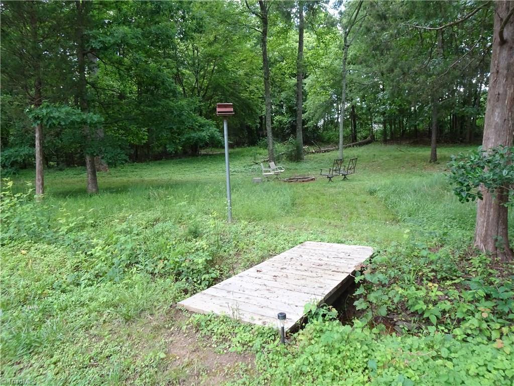 159 Nicholson Road Winston-Salem, NC 27107 - Photo 27 of 28 Charming firepit in backyard of yellow house