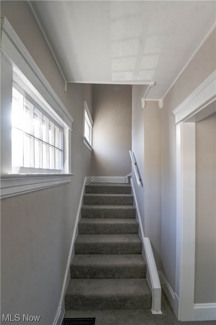 170 Avon Belden Road Avon Lake, OH 44012 - Photo 10 of 18 Staircase with crown molding and carpet