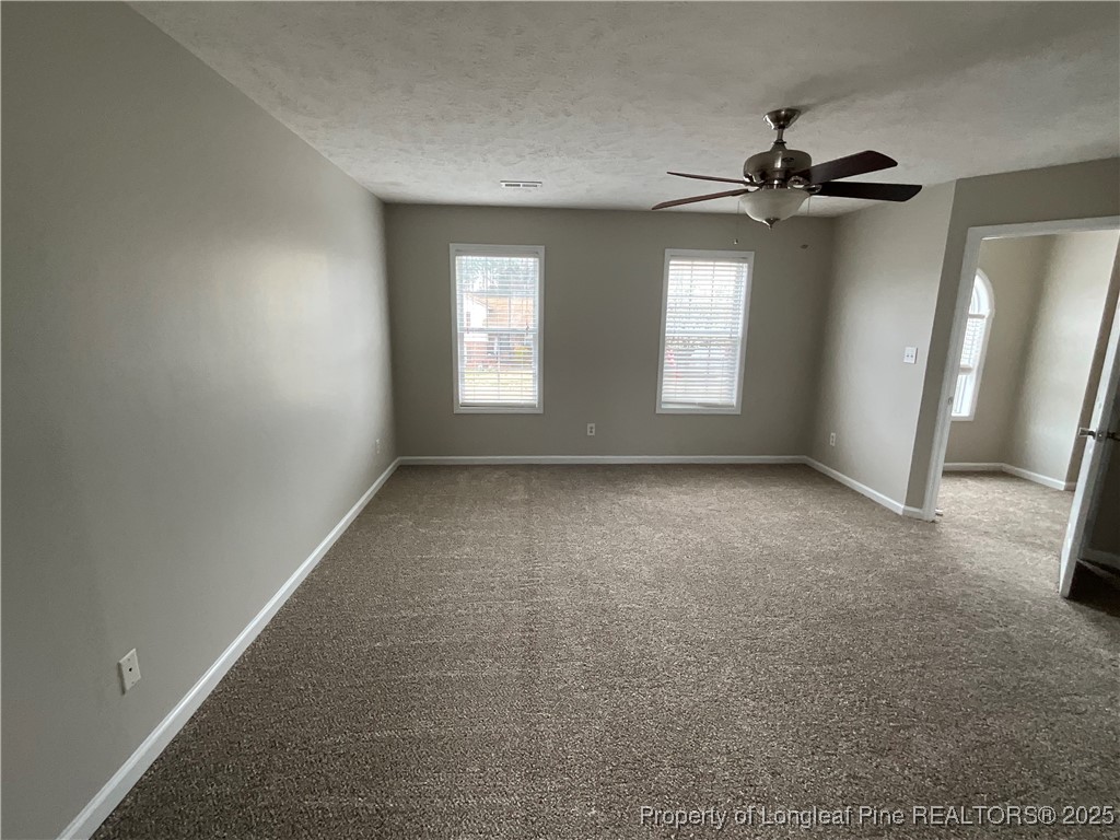 209 Pecan Trace Road Raeford, NC 28376 - Photo 15 of 24 a view of room with a ceiling fan and window