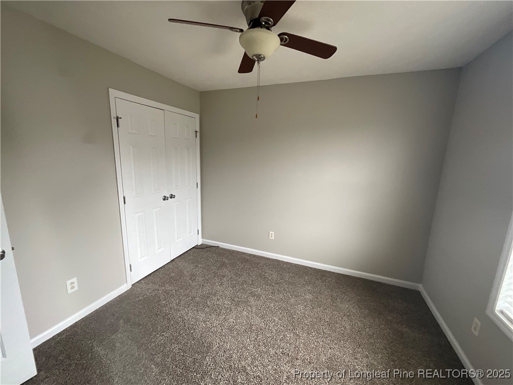 209 Pecan Trace Road Raeford, NC 28376 - Photo 8 of 24 an empty room with a ceiling fan and carpet