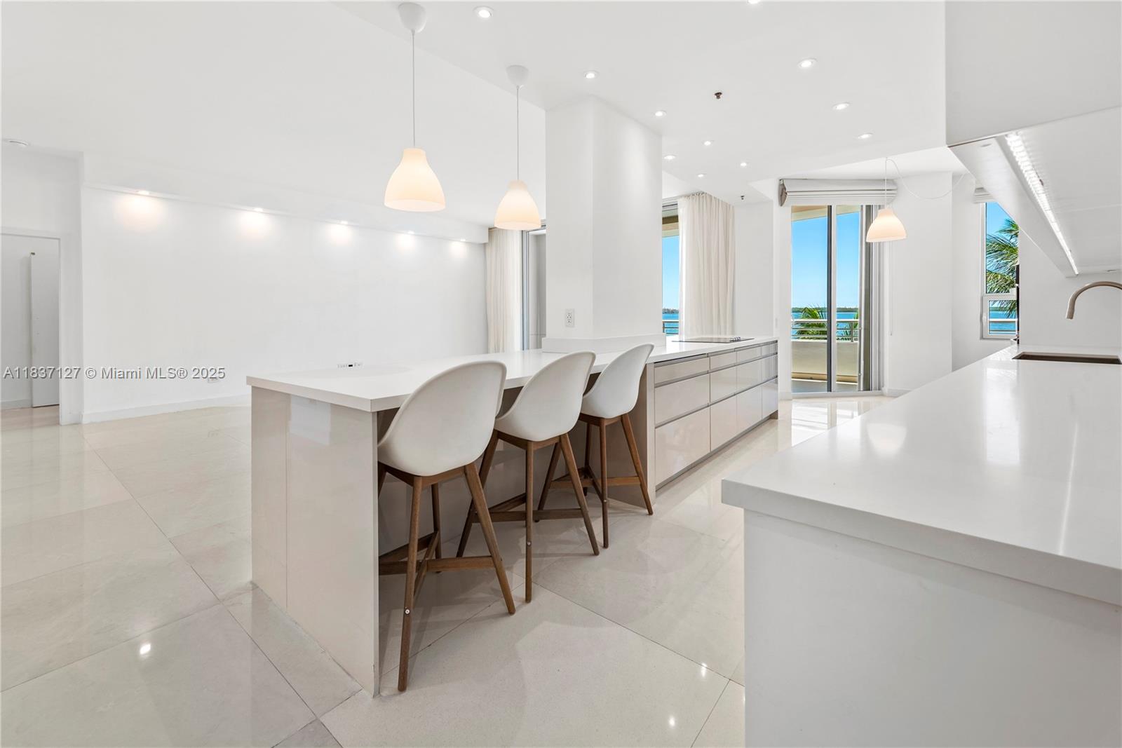 Brickell Miami, FL 33131 - Photo 11 of 65 a large room with chandelier fan and a rug