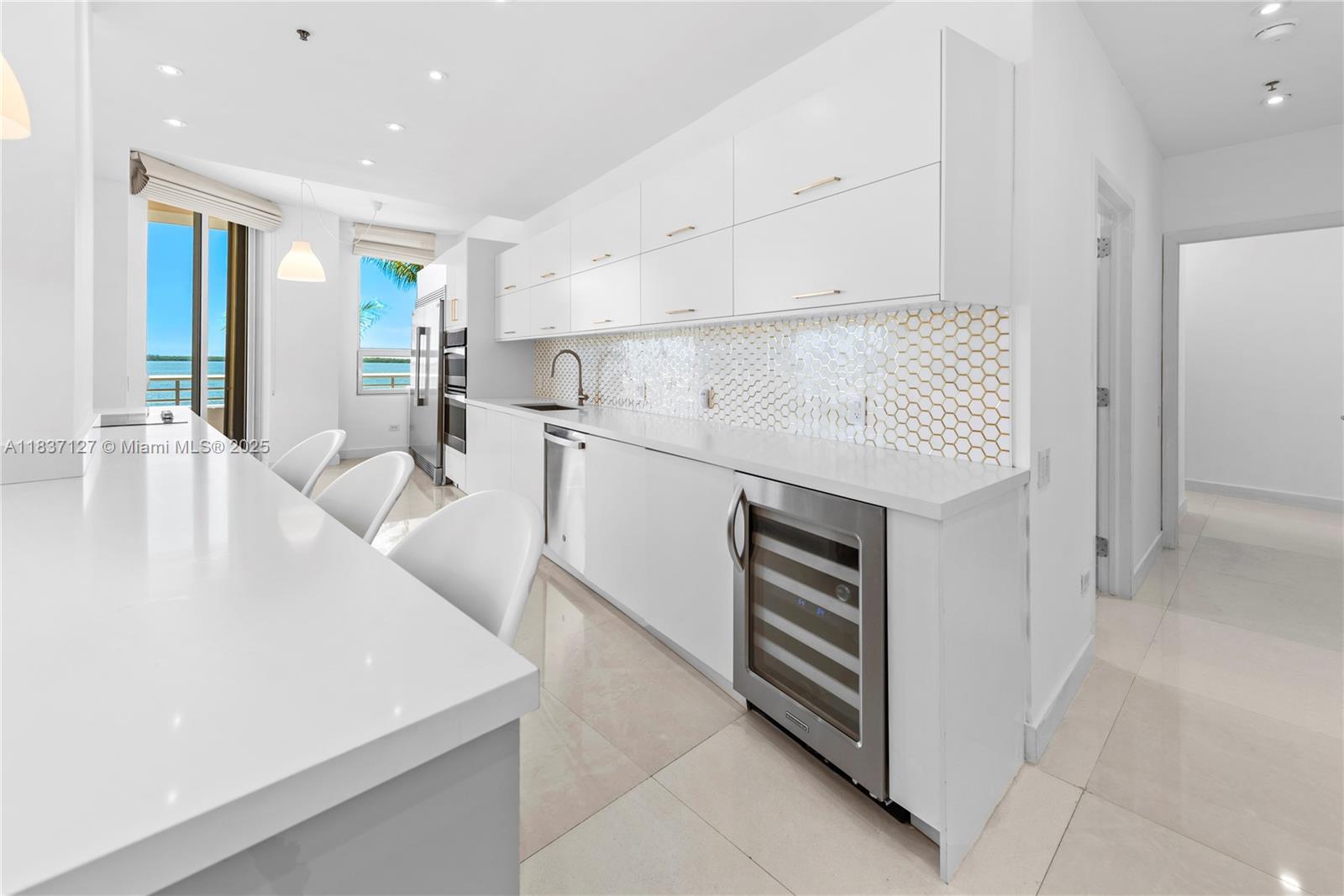 Brickell Miami, FL 33131 - Photo 13 of 65 a kitchen with a sink a stove and cabinets