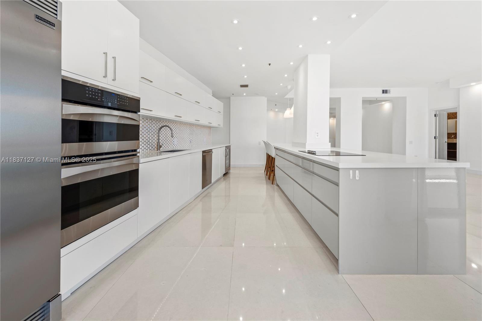 Brickell Miami, FL 33131 - Photo 16 of 65 a large white kitchen with stainless steel appliances