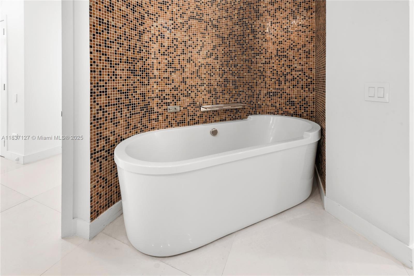 Brickell Miami, FL 33131 - Photo 40 of 65 a white bath tub sitting in a bathroom