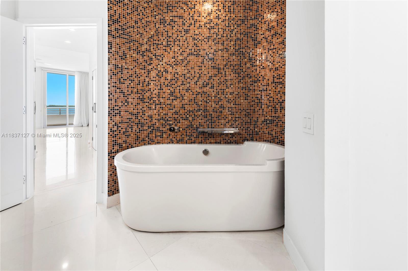 Brickell Miami, FL 33131 - Photo 41 of 65 a white bath tub sitting next to a white wall